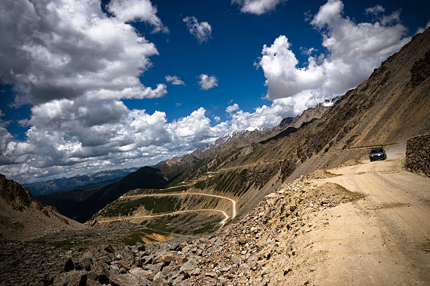 Driving on a Mountain in Tibet Driving on a Mountain in Tibet, China. horizon over land stock pictures, royalty-free photos & images