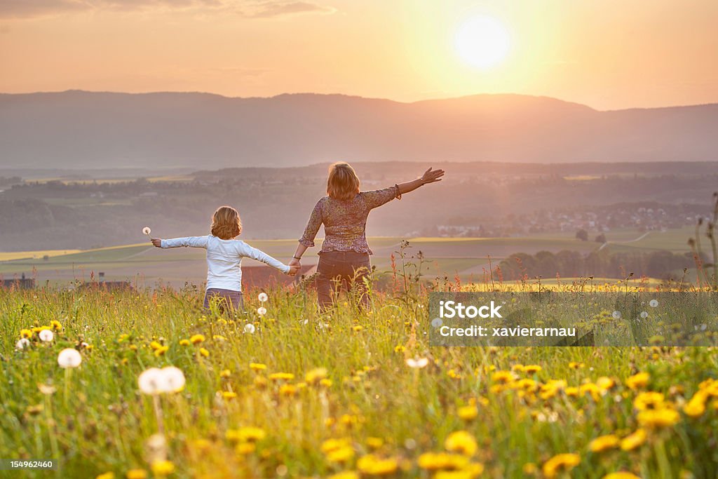Mother and daughter Mother and daughter looking at sunset. Adult Stock Photo