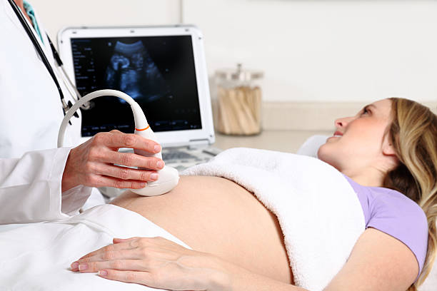 istock Woman lying down while receiving an ultrasound 154962545