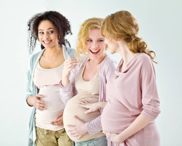 Pregnant females standing in row