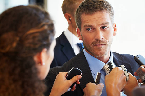 istock Male executive being questioned by journalists 154962758
