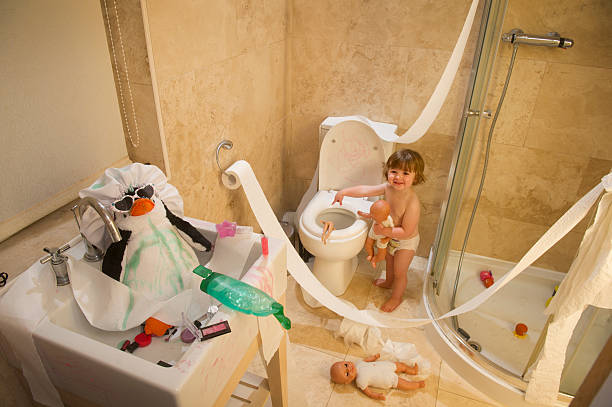 toddler mischief toddler causes mayhem in the bathroom child behaving badly stock pictures, royalty-free photos & images