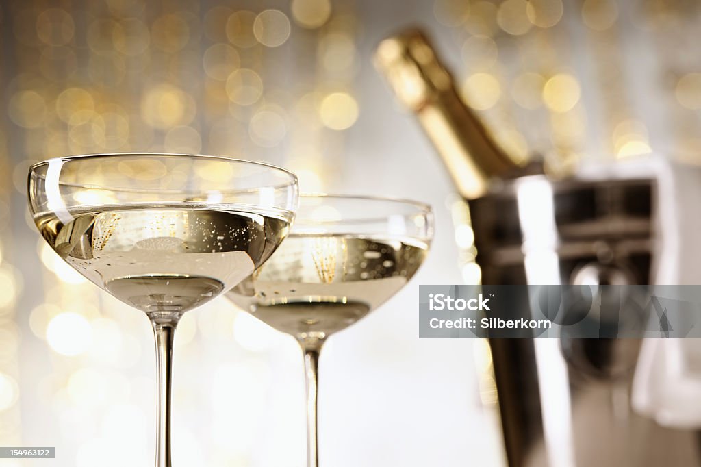 Two glasses of champagne with a blurry bucket with bottle Two glasses of champagne, bottle and cooler in the background, selective focus

[url=http://www.istockphoto.com/my_lightbox_contents.php?lightboxID=1051212][img]http://i60.photobucket.com/albums/h12/silberkorn/Wein_final.jpg[/img][/url]
 Champagne Stock Photo