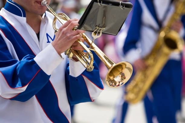 A trumpet player plays while marching in a parade
