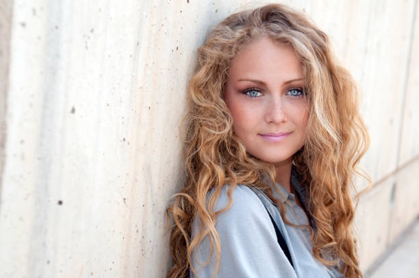 Portrait of a carefree young woman with her hair blowing in the wind
