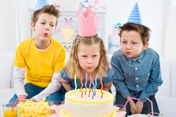 istock Blowing out candles at birthday party 154963296