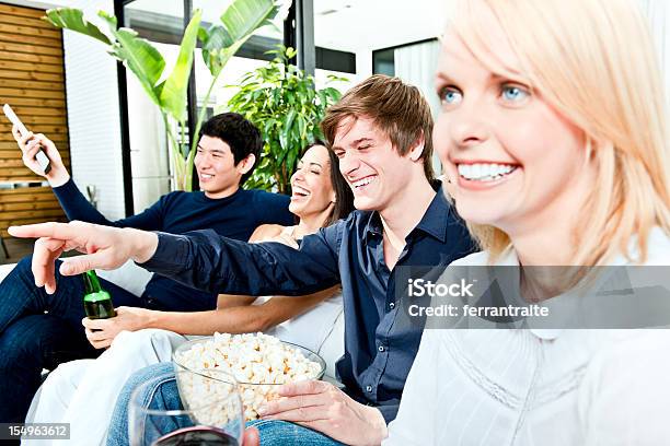 Group Of Friends Watching Tv And Laughing Stock Photo - Download Image Now - 20-29 Years, 30-39 Years, Adult