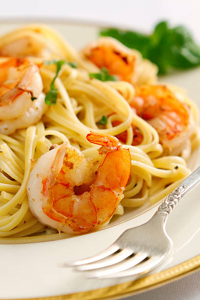 istock Shrimp scampi and linguine on a white plate with metal fork 154963631