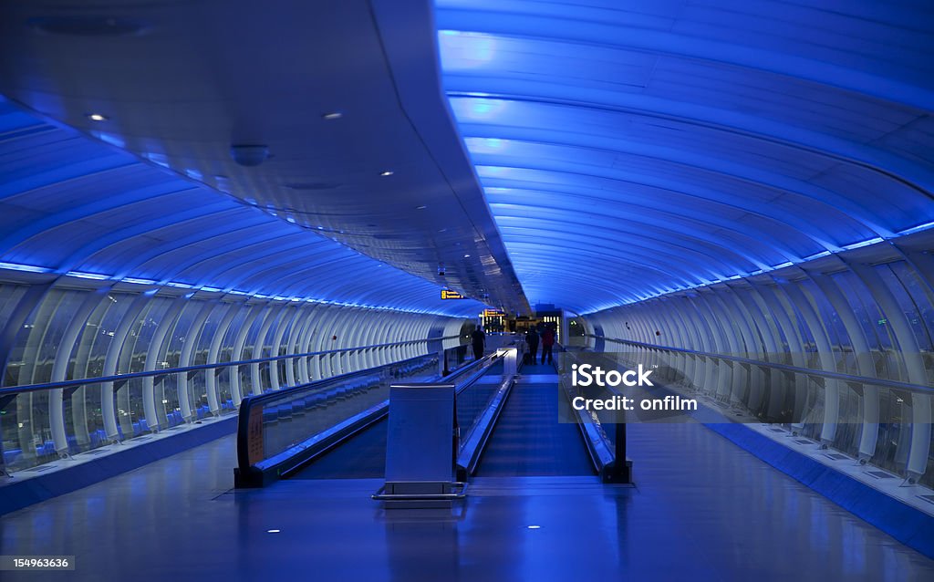 Travelator, moving walkway, blue lighting  Manchester International Airport Stock Photo