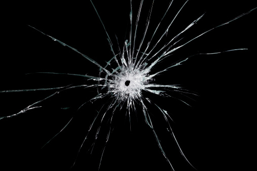 High detailed studio photographed shattered glass, cracked with hole. Isolated on black.