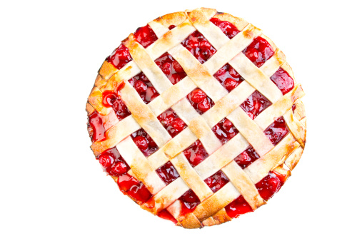 Homemade Cherry Pie fresh from the oven with a lattice crust and plump red cherries poking through.  Pie is isolated on a white background.