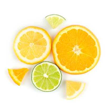 Orange, lemon, and lime slices arranged in a radial design. Isolated on white.