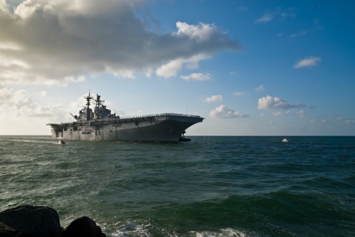 Morning sun illuminates the USS Iwo Jima (LHD-7) as she sails into Port Everglades in Fort Lauderdale, Fl..  This is a 