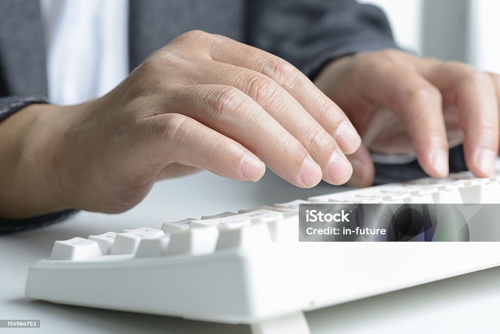 Typing Businessman is accurate in his typing Adult Stock Photo