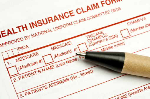 Health insurance claim form and a pen