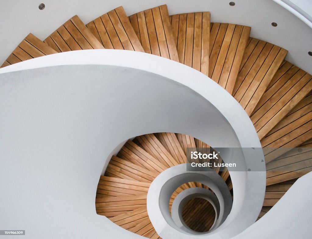 Modern spiral staircase with wooden planks Top-view photo of a spiral staircase. Forms a nautilus-shaped abstract pattern. Architecture Stock Photo