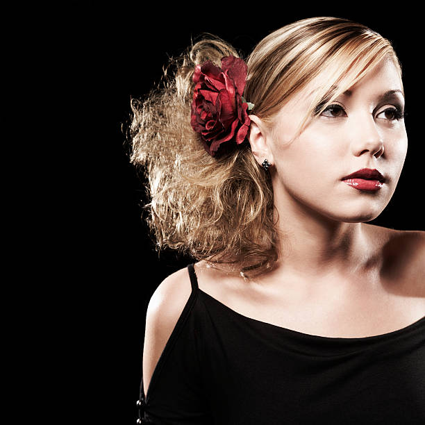 Portrait of Pretty Young Woman with Red Flower in Hair stock photo