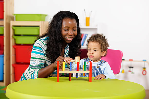 istock Toddler And Carer Playing With Multi-coloured Toys 154966372