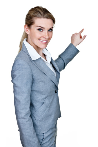 Businesswomen wearing a suit pointing to copy space and isolated on white background 