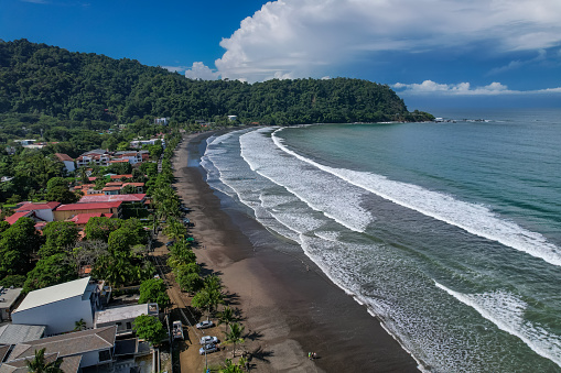 Beautiful aerial view of Jaco Beach, the surf class lessons and the suburb buildings next to the beach