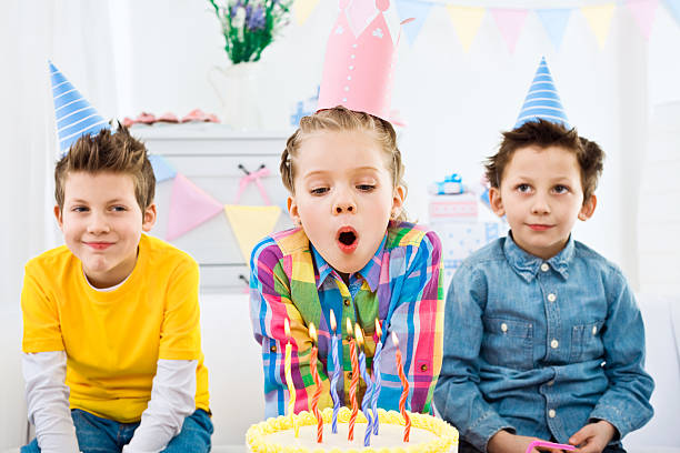 istock Blowing out candles at birthday party 154967913