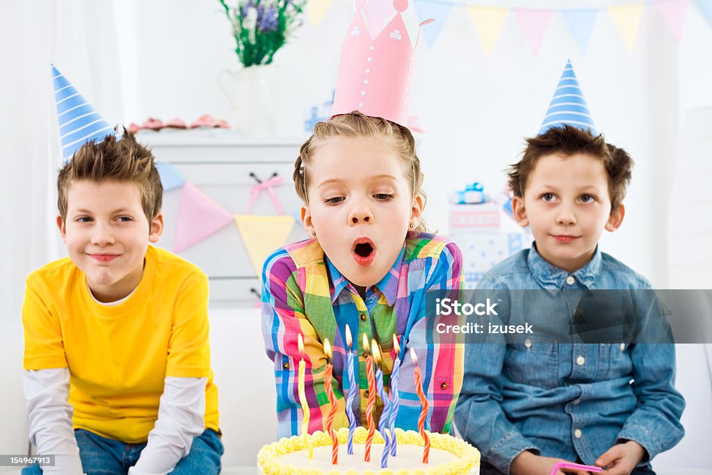 Blowing out candles at birthday party  Birthday Stock Photo