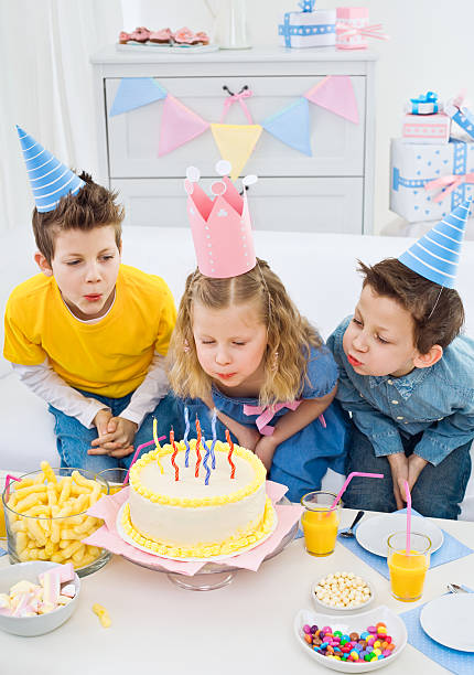 istock Blowing out candles at birthday party 154967914