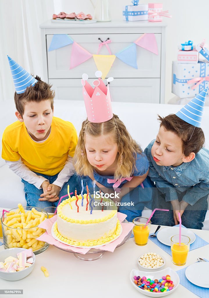Blowing out candles at birthday party  6-7 Years Stock Photo