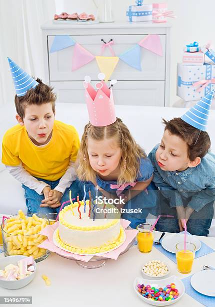Blowing Out Candles At Birthday Party Stock Photo - Download Image Now - 6-7 Years, 8-9 Years, Birthday