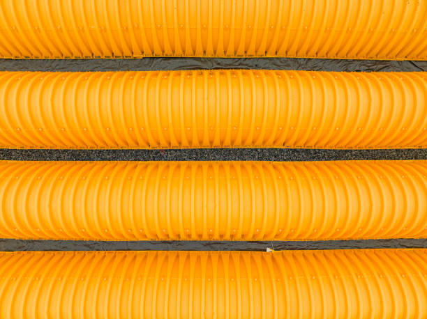 Yellow underground storm water detention mitigation units on a construction site ready to be covered.  Abstract rounded shape.