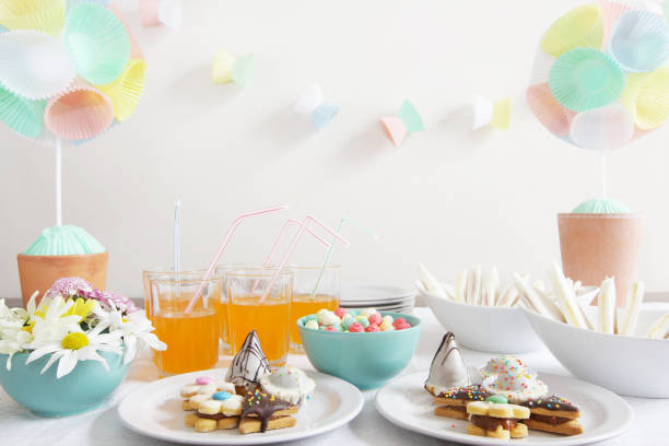 Party table with daisies, cupcake liner topiary and garlands stock photo