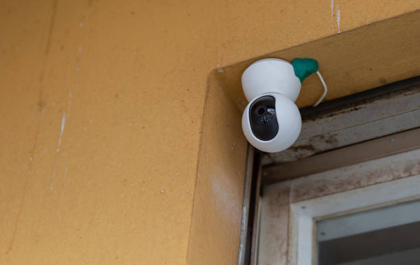 istock Security Camera, CCTV on location. Security camera on the wall in old city. 1549695174