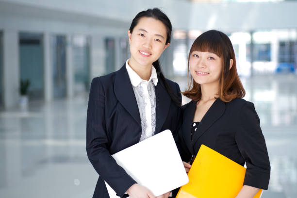 istock Two young businesswomen smiling to the camera 154970700