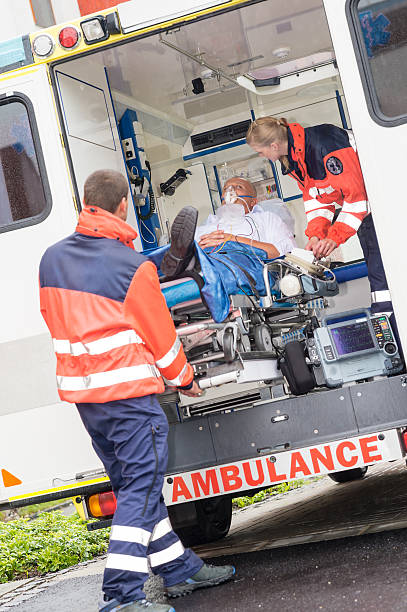 istock Paramedics putting patient in ambulance car aid 154972130