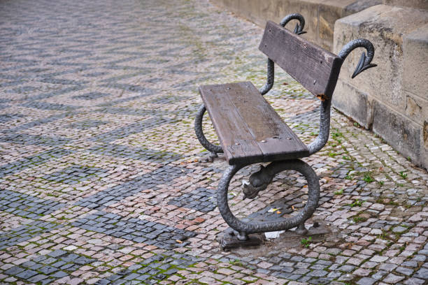 Stylish empty bench in old city stock photo