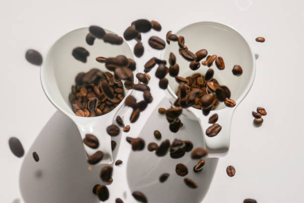 istock white cups and falling coffee beans.coffee levitation. Coffee in white cups.Traditional morning drink.Morning refreshing drink. 1549754180