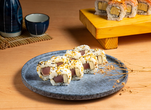 Smoked Bonito Sushi Rolls served isolated on wooden board top view of japanese food
