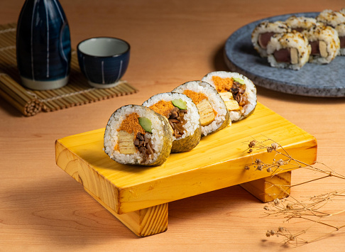 Japanese classic roll served isolated on wooden board top view of japanese food