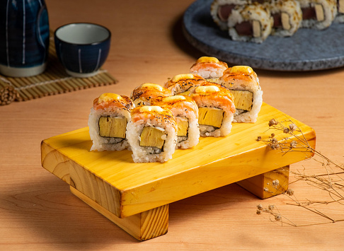 Caramelized Salmon Sushi Rolls served isolated on wooden board top view of japanese food