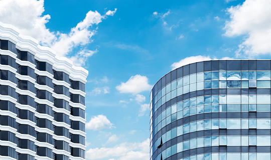 Two modern office building with blue sky background