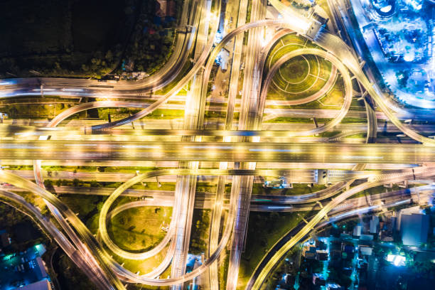 istock Traffic across junction road at night 1549937583