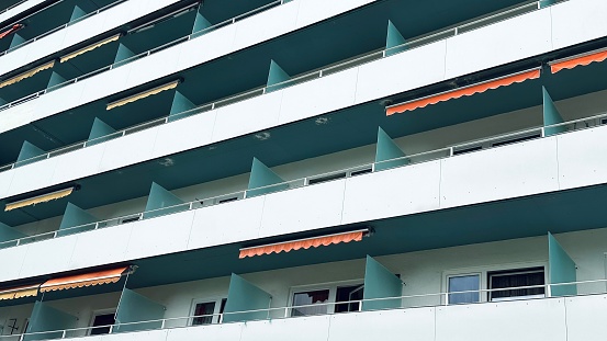 Apartments facade balconies in a row from below