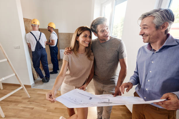 istock Happy couple talking about plans with an architect during home renovation process. 1549940270