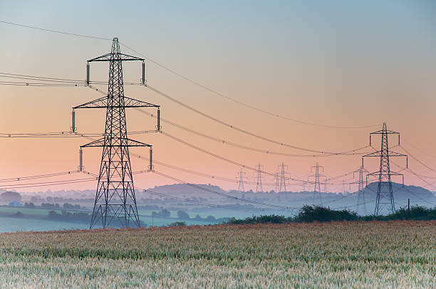 Pylons Electricity pylons and lines above farmland , England electricity pylon stock pictures, royalty-free photos & images
