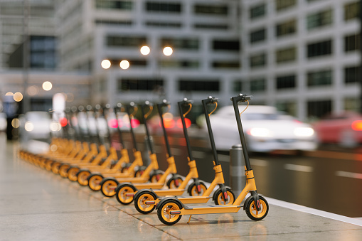 Close-up View Of Electric Push Scooters With Blurred Street Background