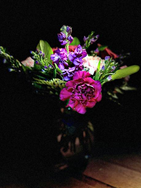 istock Studio Light Effect on Colorful Floral Arrangement Glass Vase Centerpiece on Tabletop 1549968616