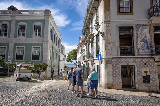 Lisbon, Portugal - Street view of Baixa district on a summer afternoon. People and cars can be seen.