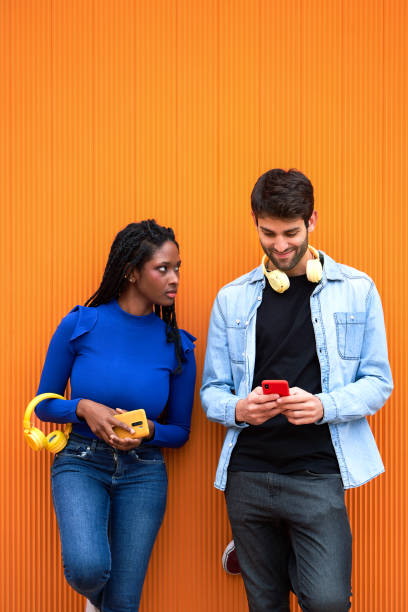 istock Angry woman looking at her boyfriend while he's using mobile phone. 1549985159