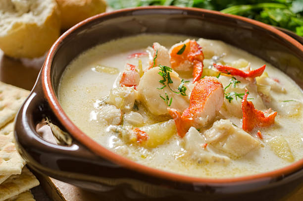 Seafood Chowder A delicious bowl of seafood chowder including lobster, scallops, clams, haddock, and halibut. Chowder stock pictures, royalty-free photos & images