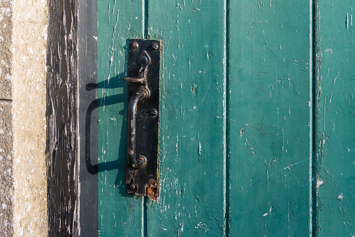 A traditional metal steel thumb catch on a shed barn workshop door, County Down, Northern Ireland, United Kingdom, UK